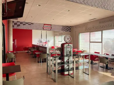 a restaurant with a soda machine in the middle of the room at Area 507 in Outeiro de Rei