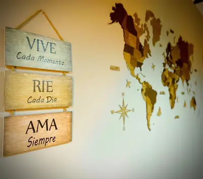 a world sign hanging on a wall with a world map at Casa rural O CARBALLO DA PEDRA in La Cañiza