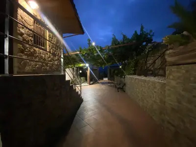 a walkway leading to a building at night at Casa rural O CARBALLO DA PEDRA in La Cañiza