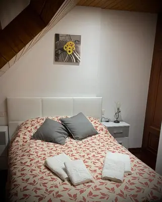 a bedroom with a bed with two pillows on it at A boa vista in Melide