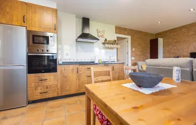 a kitchen with wooden cabinets and a bowl on a wooden table at 
