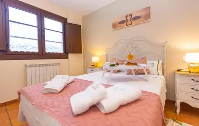 a bedroom with a large bed with two white pillows at 