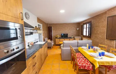 a kitchen and living room with a table and a couch at 
