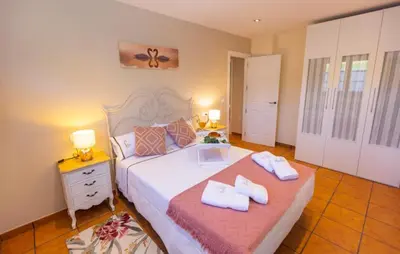 a bedroom with a bed with two towels on it at 