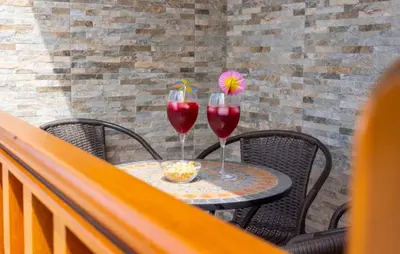 two glasses of red wine sitting on a table at 