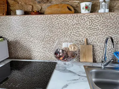 a kitchen counter with a sink and a wine glass at Estudio Pajar rural con bonito jardín - Los Gayoles Rural in Castropol