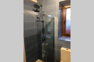 a bathroom with a glass shower with a toilet at Estudio Pajar rural con bonito jardín - Los Gayoles Rural in Castropol
