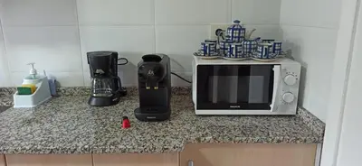 a kitchen counter with a microwave and a coffee maker at El Mirador de la Villa in Puebla de Sanabria