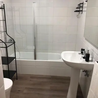 a bathroom with a sink and a bath tub at El Mirador de la Villa in Puebla de Sanabria
