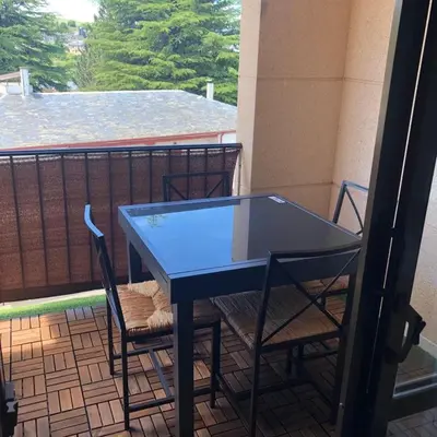 a blue table and chairs on a balcony at El Mirador de la Villa in Puebla de Sanabria