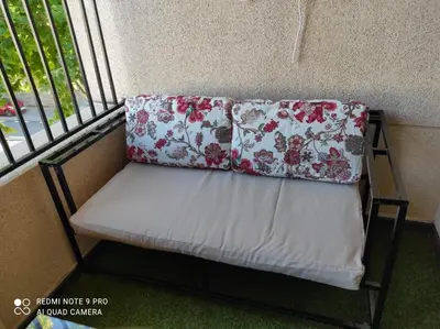 a bench with two pillows on it in a room at El Mirador de la Villa in Puebla de Sanabria