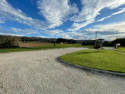an empty road with a tree in the middle at AT El Manzano - Jardín & BBQ - Los Gayoles Rural in Castropol