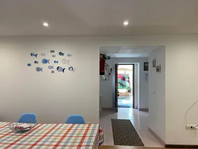 a dining room with a table and blue chairs at AT El Manzano - Jardín & BBQ - Los Gayoles Rural in Castropol