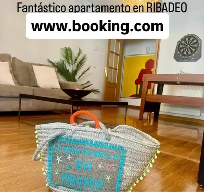 a blue and white bag sitting in a living room at FANTASTICO APARTAMENTO EN RIBADEO in Ribadeo