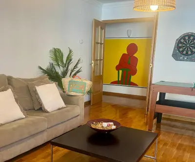 a living room with a couch and a table at FANTASTICO APARTAMENTO EN RIBADEO in Ribadeo