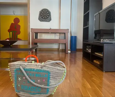 a rattan purse sitting on the floor in a living room at FANTASTICO APARTAMENTO EN RIBADEO in Ribadeo