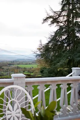 a white railing on a porch with a tree at Casa con finca en Pol, Monforte de Lemos in Monforte de Lemos