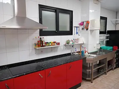 a kitchen with red cabinets and a counter top at A Fonte De Compostela in Santiago de Compostela