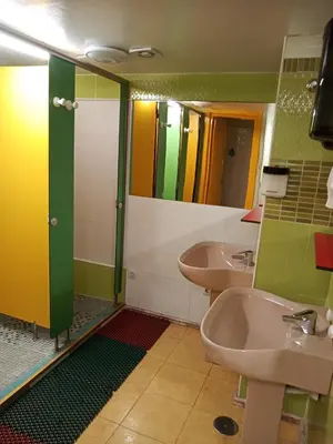 a bathroom with two sinks and two mirrors at A Fonte De Compostela in Santiago de Compostela