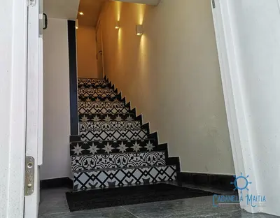 a stairway with a black and white patterned staircase at Cabanela Maitia Apto Matteo Barbacoa in Ribadeo