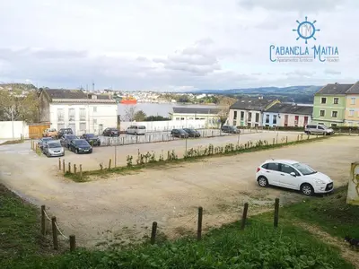 a group of cars parked in a parking lot at Cabanela Maitia Apto Matteo Barbacoa in Ribadeo
