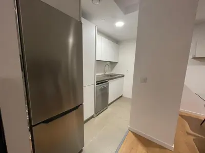 a kitchen with a stainless steel refrigerator and a sink at Oktheway Areal in Oleiros