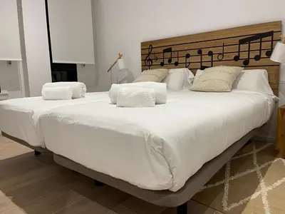 a large white bed with white sheets and pillows at Oktheway Areal in Oleiros
