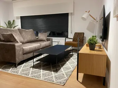 a living room with a couch and a table at Oktheway Areal in Oleiros