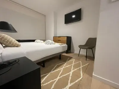 a bedroom with a bed and a desk and a chair at Oktheway Areal in Oleiros