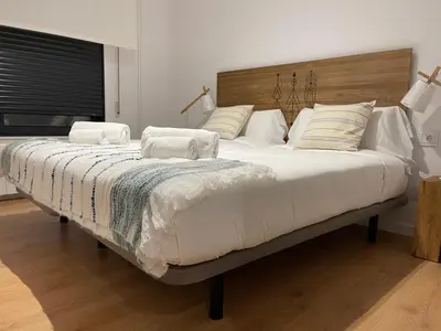 a bedroom with a large bed with white sheets and pillows at Oktheway Areal in Oleiros