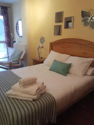 a bedroom with a bed with towels on it at Apartamento en Viveiro (Casco histórico) in Viveiro