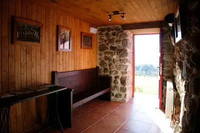 a room with a fireplace and a stone wall at Casa Baralló in Lobios