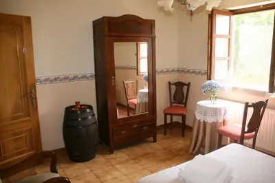 a room with a barrel and a mirror and a table at Casa Pousadoira in Miño