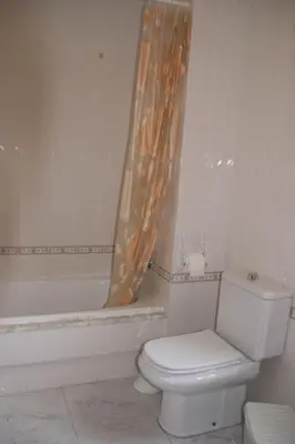 a bathroom with a toilet and a shower curtain at Casa Pousadoira in Miño