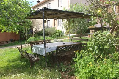 a table and chairs under a canopy in a garden at Casa Pousadoira in Miño