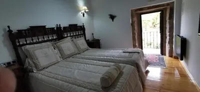a bedroom with a large bed in a room at Casa Rousia in Baltar