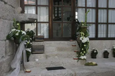 a set of stairs with flowers in front of a building at Casa Rousia in Baltar