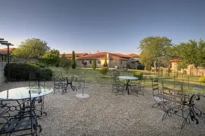 a group of tables and chairs in a yard at Casa Rousia in Baltar
