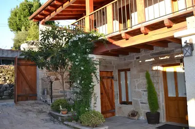 a house with a wooden door and a porch at Casa Brues in Boborás
