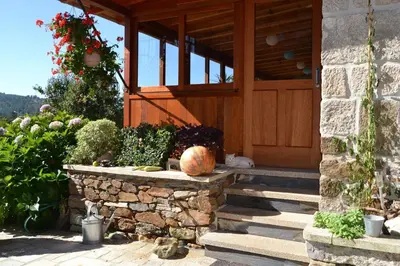 a porch of a house with a pumpkin on the steps at Casa Brues in Boborás