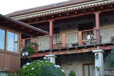 a house with balconies on the side of it at Casa Brues in Boborás