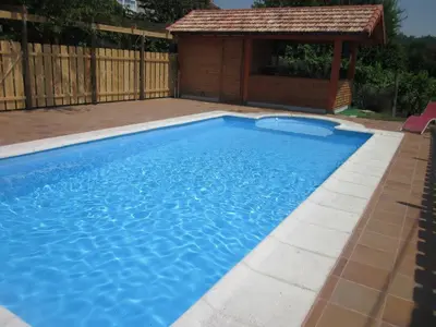 a large blue swimming pool with a gazebo at Casa Brues in Boborás