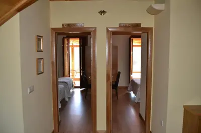 a hallway with two doors and a room with a bed at Casa Brues in Boborás