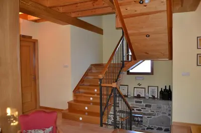 a winding staircase in a home with wooden beams at Casa Brues in Boborás
