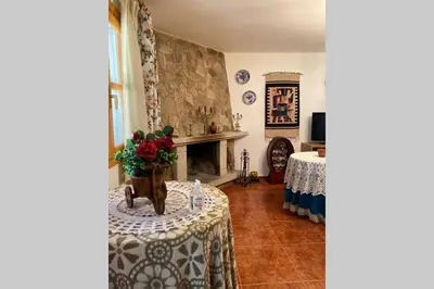 a living room with a table and a fireplace at Casa rural: Villa Marías in Sampil