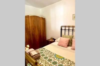 a bedroom with a bed and a dresser and a mirror at Casa rural: Villa Marías in Sampil