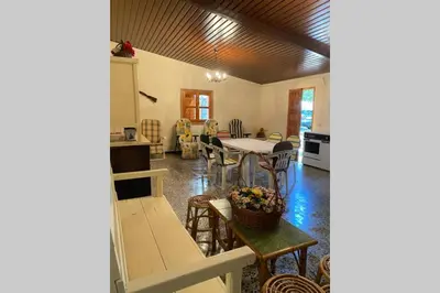 a house with a patio with chairs and trees at Casa rural: Villa Marías in Sampil