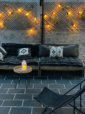 a black couch with pillows and a table and lights at ACASADACONCHA in Moeche