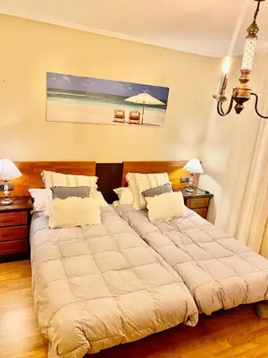 a bedroom with two beds and a picture of the beach at ACASADACONCHA in Moeche
