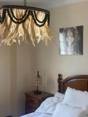 a bedroom with a bed with a curtain and a lamp at ACASADACONCHA in Moeche